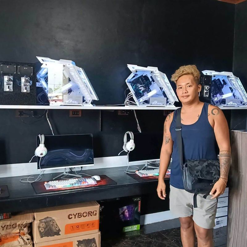 Happy owner with his brand-new gaming café setup